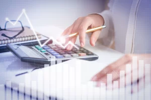 Professional analyzing financial data on calculator with accounting graphs and performance charts representing best practices in financial accounting for improved business decisions