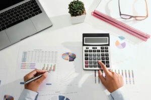 businesswoman working desk using calculator laptop analyzing finance accounting office 34152 2162 (1)