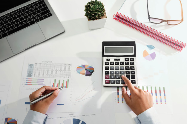 businesswoman working desk using calculator laptop analyzing finance accounting office 34152 2162 (1)